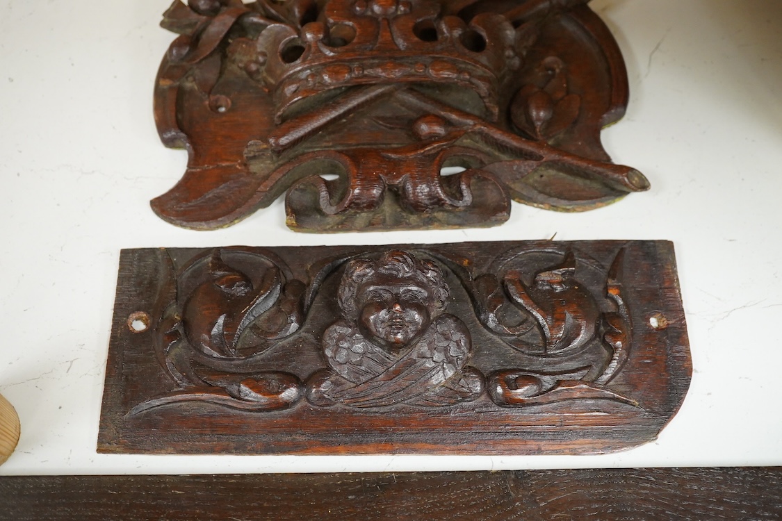 Three 18th century and later carved oak panels, one carved with a coronet, largest 46cm wide